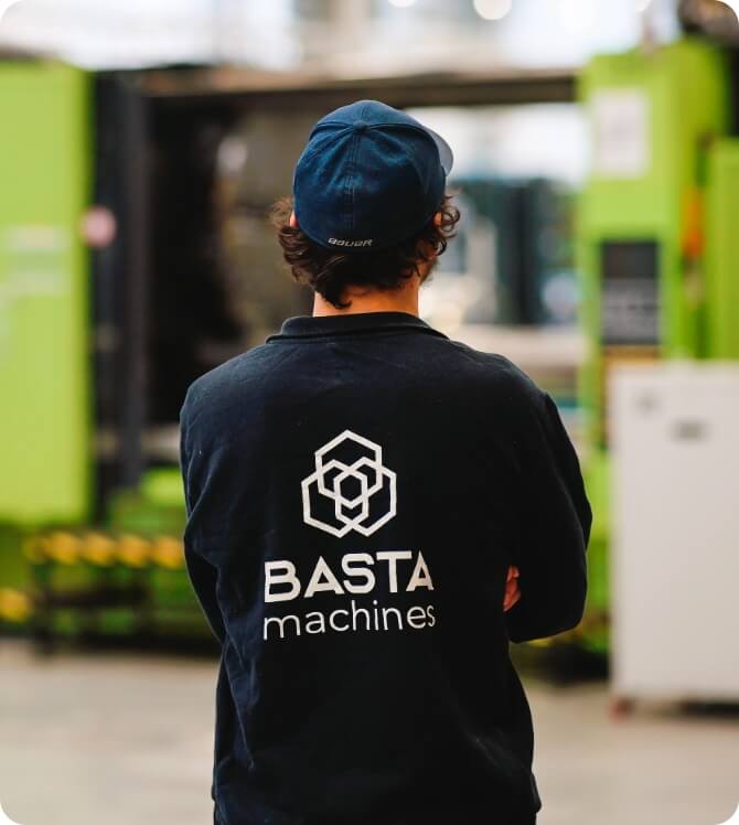 Man standing and looking at a warehouse.