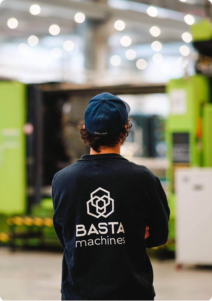 Man standing and looking at a warehouse.