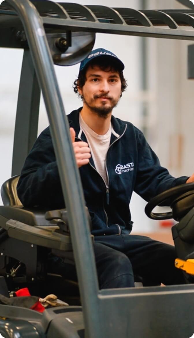 Warehouse worker operating a forklift.