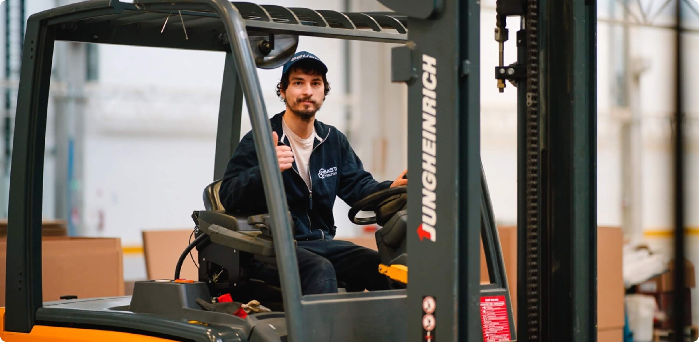 Warehouse worker operating a forklift.